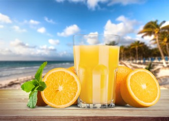 Orange fruit juice on the beach © BillionPhotos.com