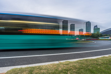 urban city road with motion bus at twilight, china.