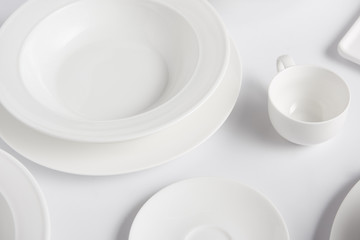 selective focus of different plates and cup on white table