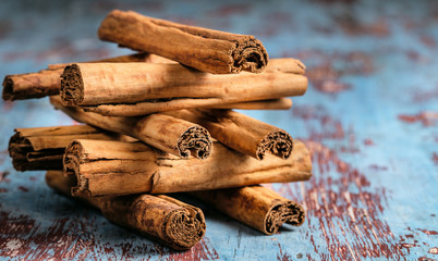 Fresh Indian cinnamon sticks on blue wooden table