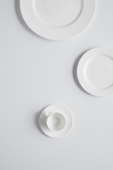 elevated view of different plates and cup on white table