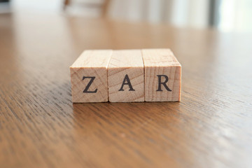 ZAR (South African Rand) Text Block on Wooden Table