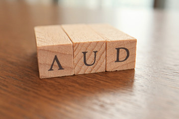 AUD (Australian Dollar) Text Block on Wooden Table