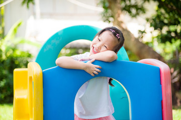 Fototapeta na wymiar Little asian girl smiling while playing in playground