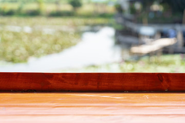 Wooden table top with blurred green garden background.