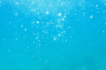 Underwater turquoise texture in ocean. Bubbles in tropical sea.