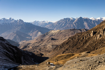 The way down after the Thorung La pass toward Muktinath and the Mustang valley along the Annapurna circuit trek in the Himalayas in Nepal