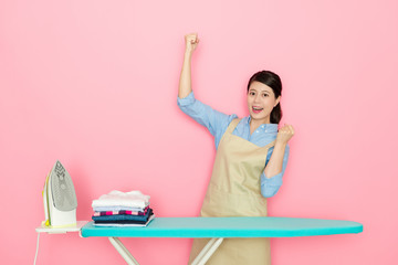 Fototapeta na wymiar Happy housewife successful finish the ironing