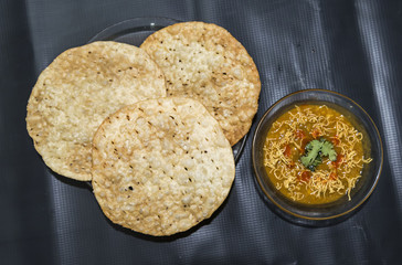 Dal Pakwan - The famous Sindhi cuisine- crispy deep fried flat bread with cooked spiced lentils (chanadal), mint chutney, tamarind-date chutney and onions and cilantro