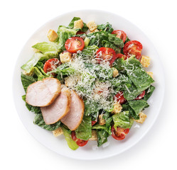 Caesar salad with chicken fillet and parmesan cheese isolated on white background.