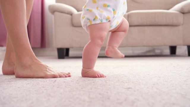 Baby girl walking her first steps