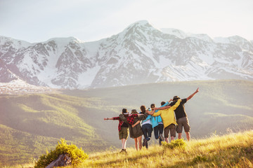 Group of happy friends against mountains