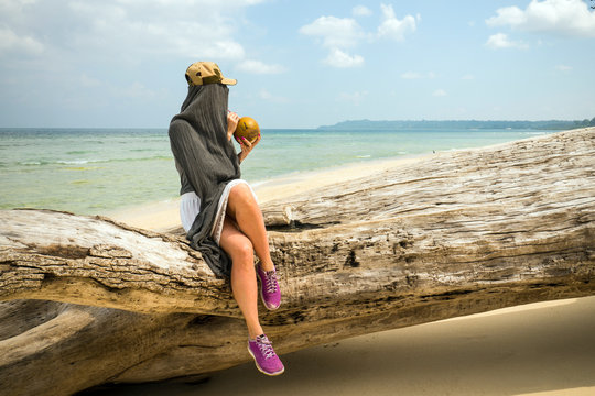 beach profile girl drinking a coconut fresh cocktail in tropical sea