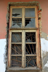 Fototapeta na wymiar Old wooden window with a lattice and broken glass