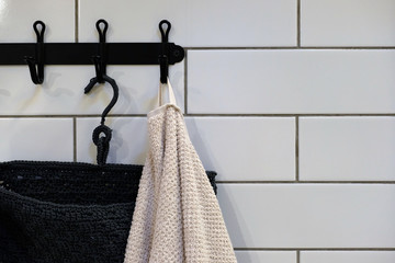 Clean Colored towels hanging on the rack in the bathroom. Focus on the top of the hook and towels