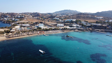Aerial drone bird's eye view from famous beach of Paraga with emerald waters, Mykonos island, Cyclades, Greece