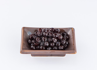  black pearls. Boiled tapioca pearls for bubble tea on white background. Copy space