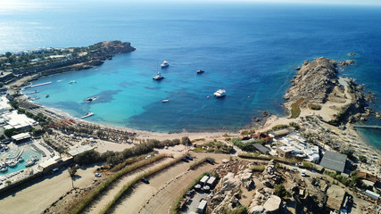 Aerial drone bird's eye view from famous beach of Paraga featuring famous night club of Skorpios...
