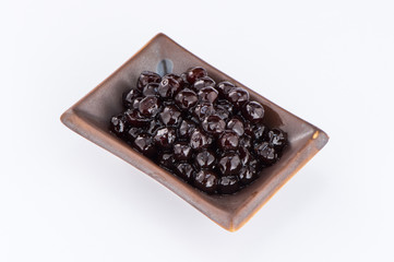  black pearls. Boiled tapioca pearls for bubble tea on white background. Copy space