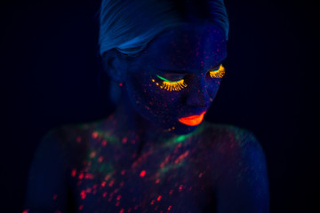 Portrait of Beautiful Fashion Woman in Neon UF Light. Model Girl with Fluorescent Creative Psychedelic MakeUp, Art Design of Female Disco Dancer Model in UV, Colorful Abstract Make-Up