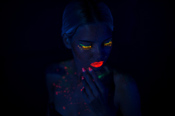 Portrait of Beautiful Fashion Woman in Neon UF Light. Model Girl with Fluorescent Creative Psychedelic MakeUp, Art Design of Female Disco Dancer Model in UV, Colorful Abstract Make-Up