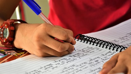 A girl writing gratitude on a pad.