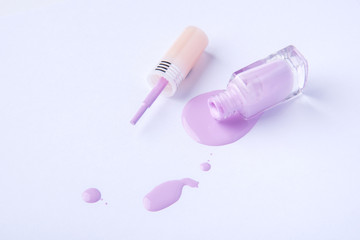 Drops and blobs from spilled nail polish on a white background