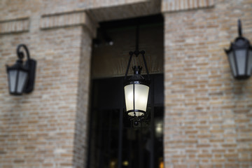 Fototapeta na wymiar Brick wall building with light lamp