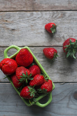 Fresh organic strawberry on rustic wooden background. Healthy lifestyle, summer berries, top view, selective focus