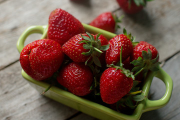 Fresh organic strawberry on rustic wooden background. Healthy lifestyle, summer berries, selective focus