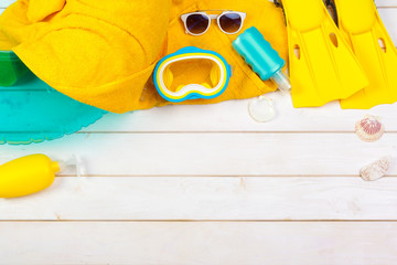 Bright yellow flippers and diving mask on a vibrant backround