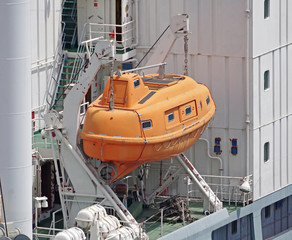orange lifeboat on ship