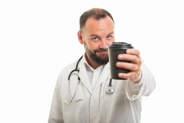 Portrait of male doctor handing to go coffee cup