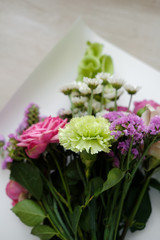 pink bouquet of carnations and roses.  bouquet of flowers indoor in flower shop. Close up. Top view. Mother's Day and Valentine's Day concept 