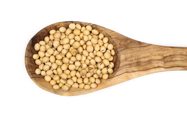 Organic raw soybeans in wooden spoon, isolated on white background, top view