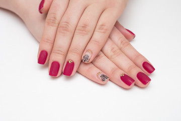 Closeup of hands of a young woman with red manicure on nails