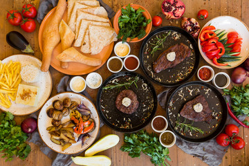 Variety of food grilled on wooden table, top view. Outdoors food Concept