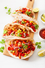 mexican beef and pork tacos with salsa, guacamole and vegetables