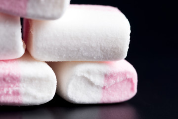 Marshmallow on a dark background, close-up.