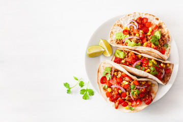 mexican beef and pork tacos with salsa, guacamole and vegetables