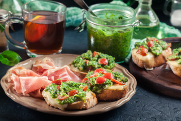 Bruschetta with fresh pesto, mozzarella and cherry tomatoes on a plate