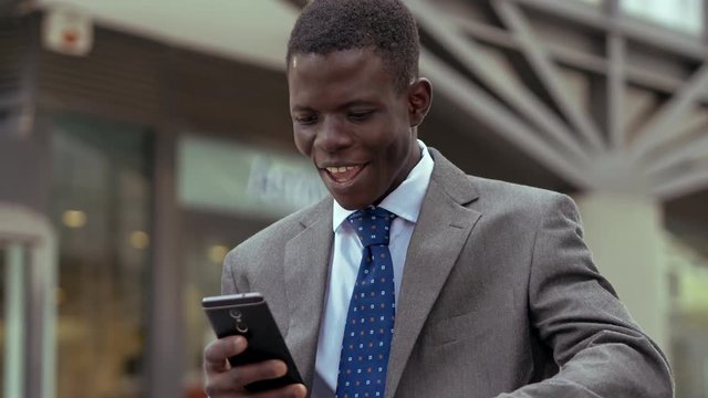 Success,winning.happy young black business man rejoicing for  good news on phone