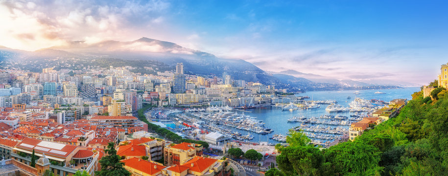 Principality of Monaco. Beautiful panoramic view on Monaco, golden hour scenery. View on apartment building, casino, great port with luxury yachts. Monaco is popular travel destination, wealth symbol.