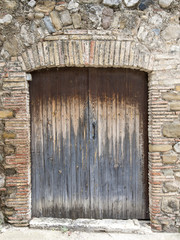 The old big ancient wooden door in Spain.
