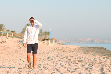 man walk on beach during sunrise