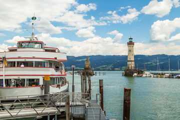 Fototapeta na wymiar The Lindau Lighthouse and a Lion sculpture at the lake Constance (Bodensee) in Germany, Bavaria