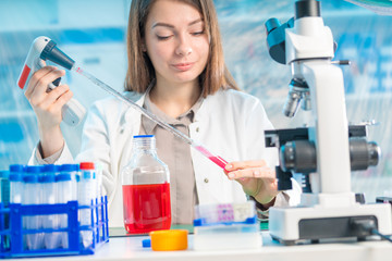 Chemical laboratory scientist woman working with pipette