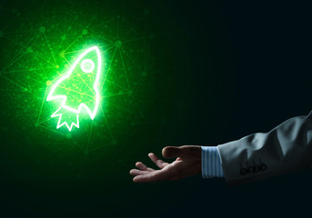 Man palm presenting Rocket web icon as technology concept