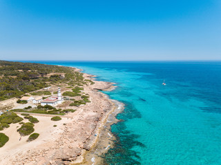 Fototapeta na wymiar Aerial: Cape Ses Salines lighthouse in Mallorca