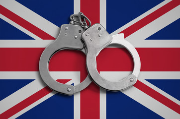 Great britain flag  and police handcuffs. The concept of observance of the law in the country and...